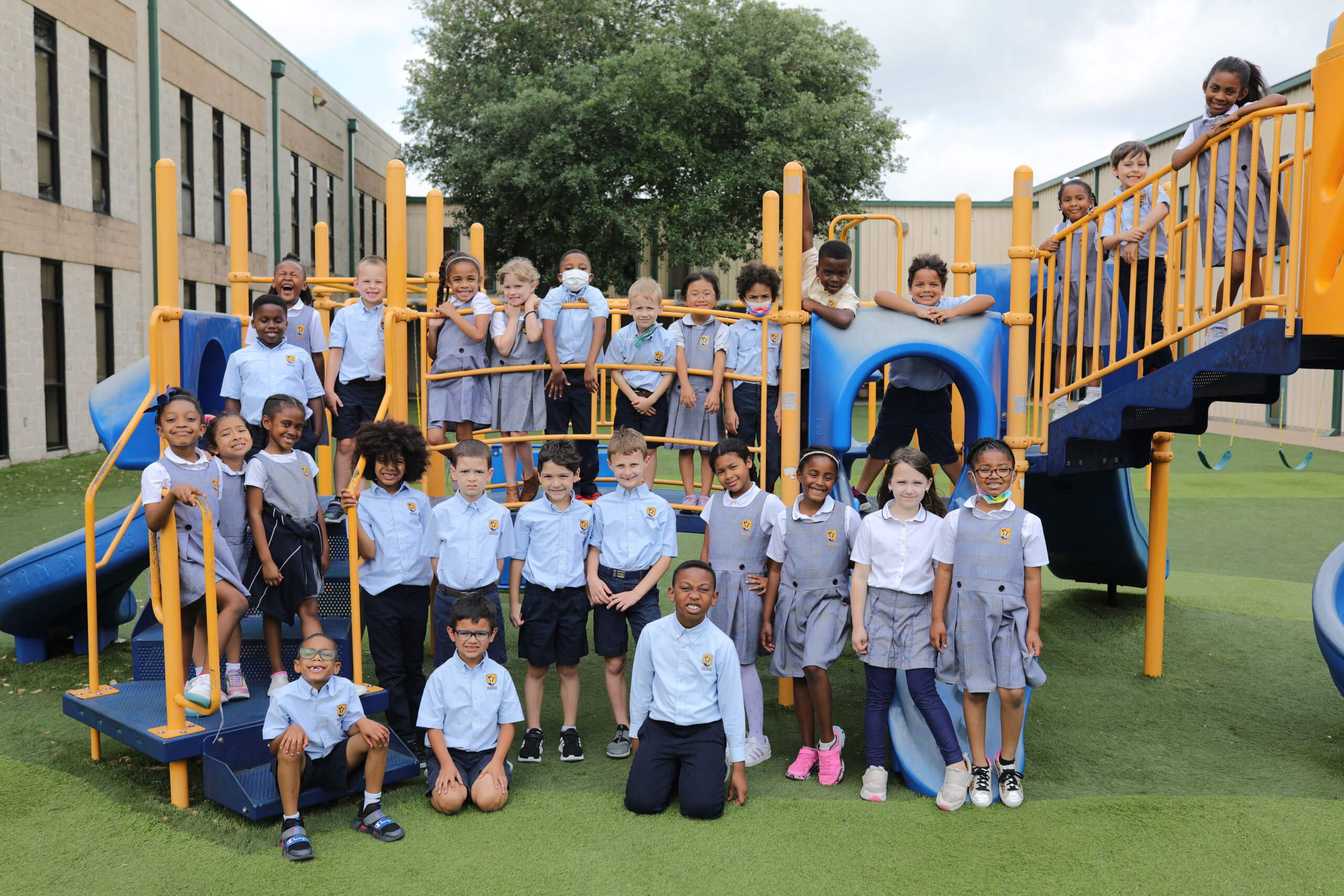 Elementary students waving on the playground