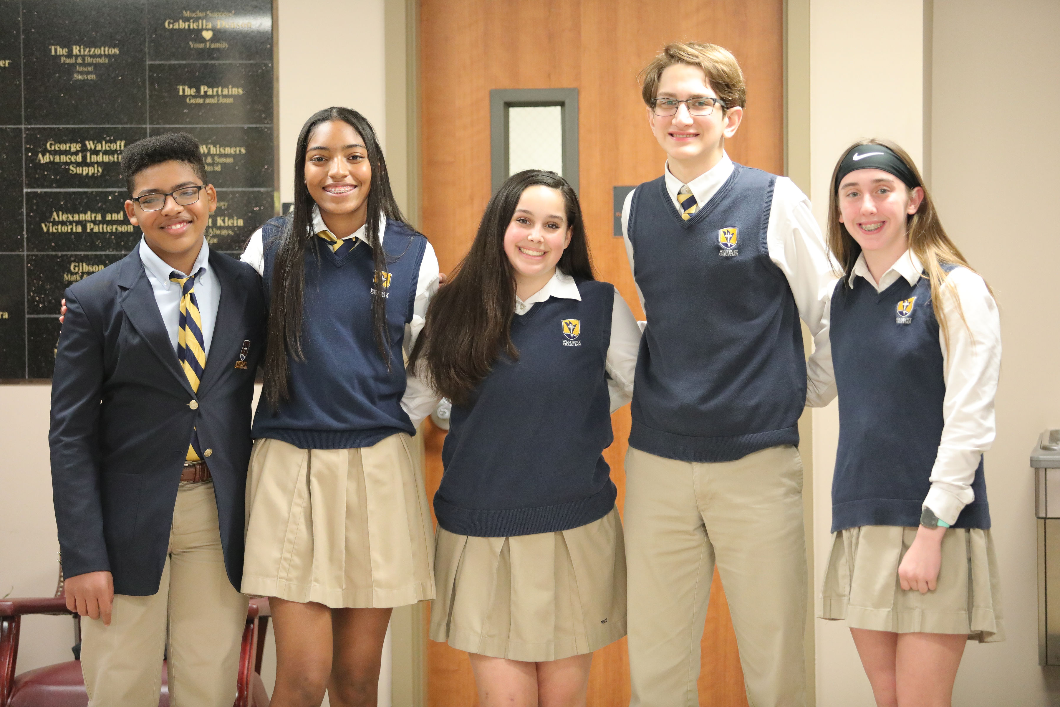 Middle school and high school students in academic hallway