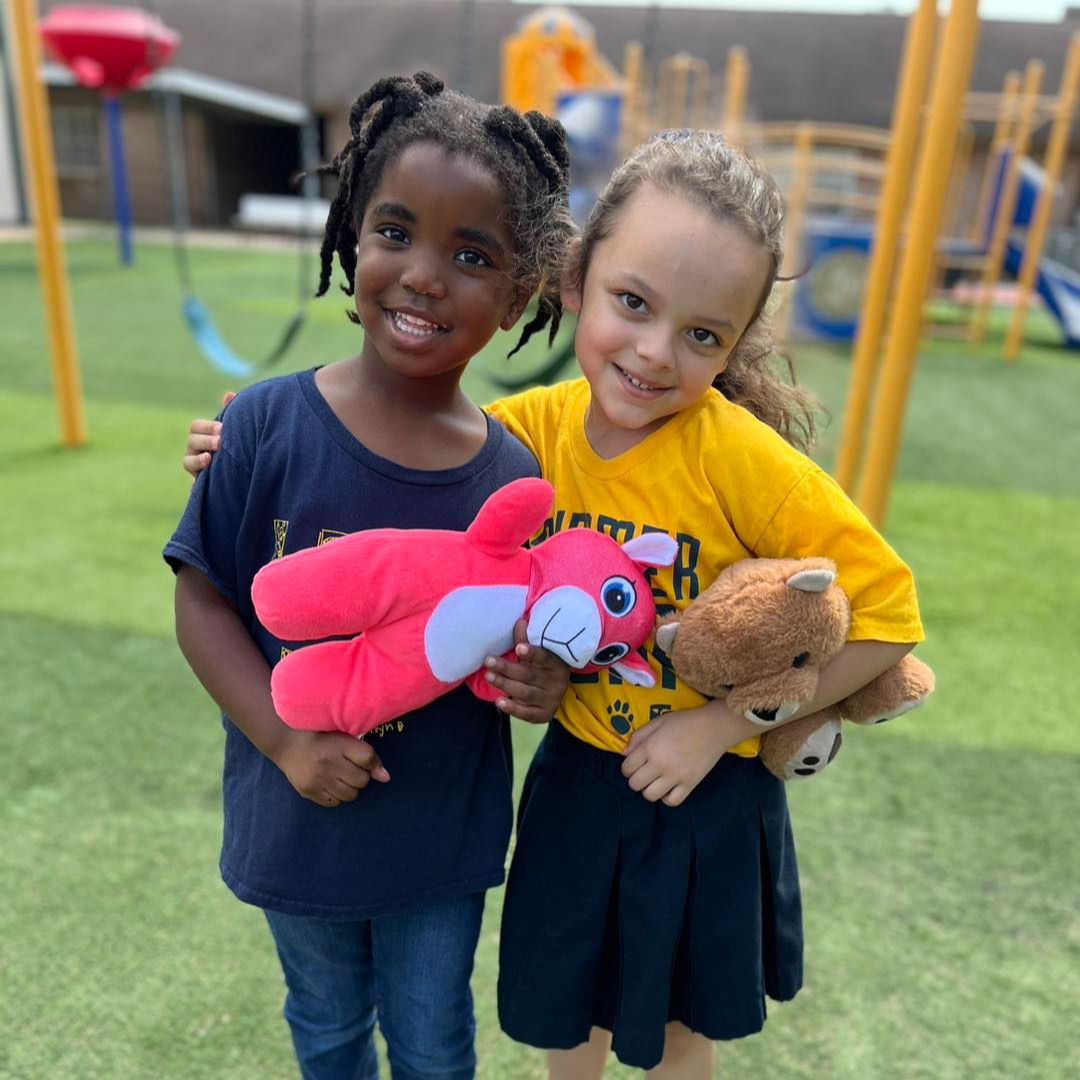 Two preschool girls smiling on Teddy Bear Day