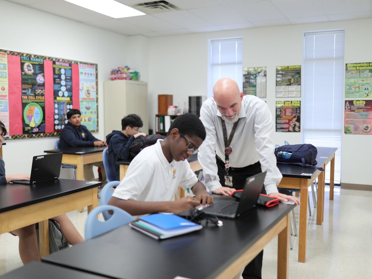 High School Science Teacher giving student individualized attention