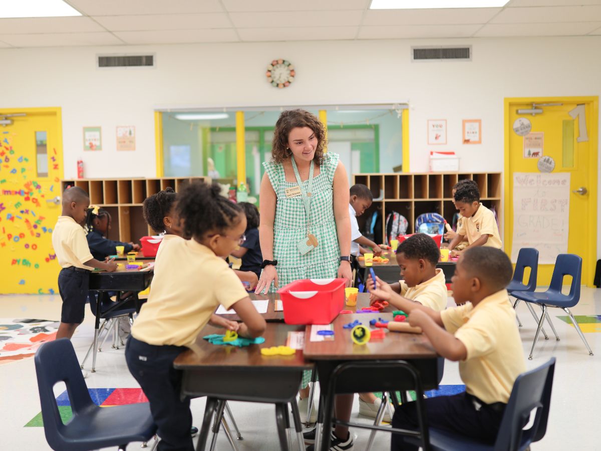 1st grade teacher greets students on first day of school